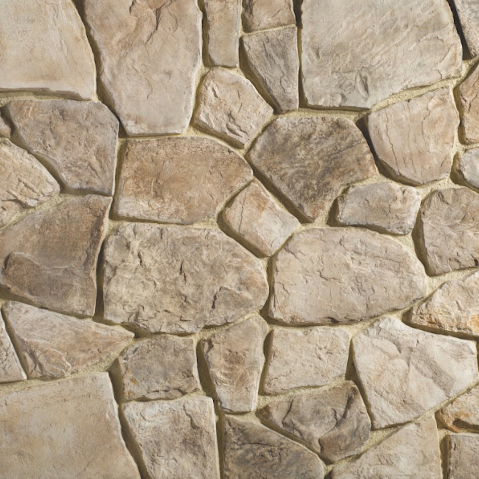 A stone veneer wall mimicking Irregular rubble stone with angular shapes and planer faces in the shade Timberwolf.