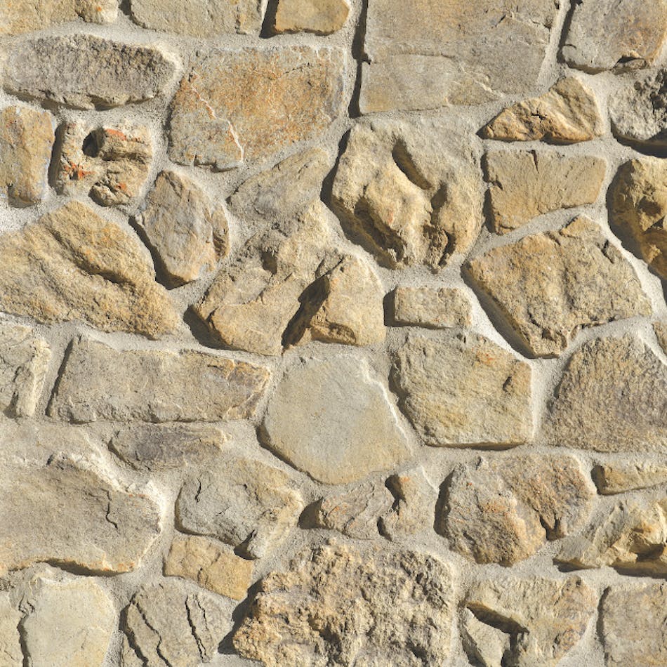 A gray and tan stone veneer wall mimicking rustic stones in varying shapes, sizes, and textures. Shown here in Coyote color palette.