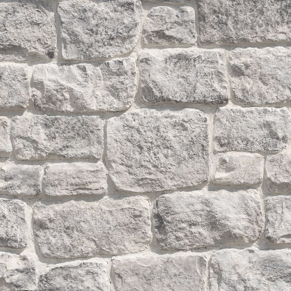 Wall of irregularly placed stone veneer.