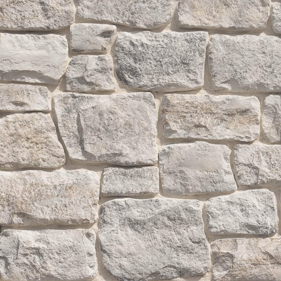 A close-up of a wall with Craft Orchard Limestone in the color Wildflower.