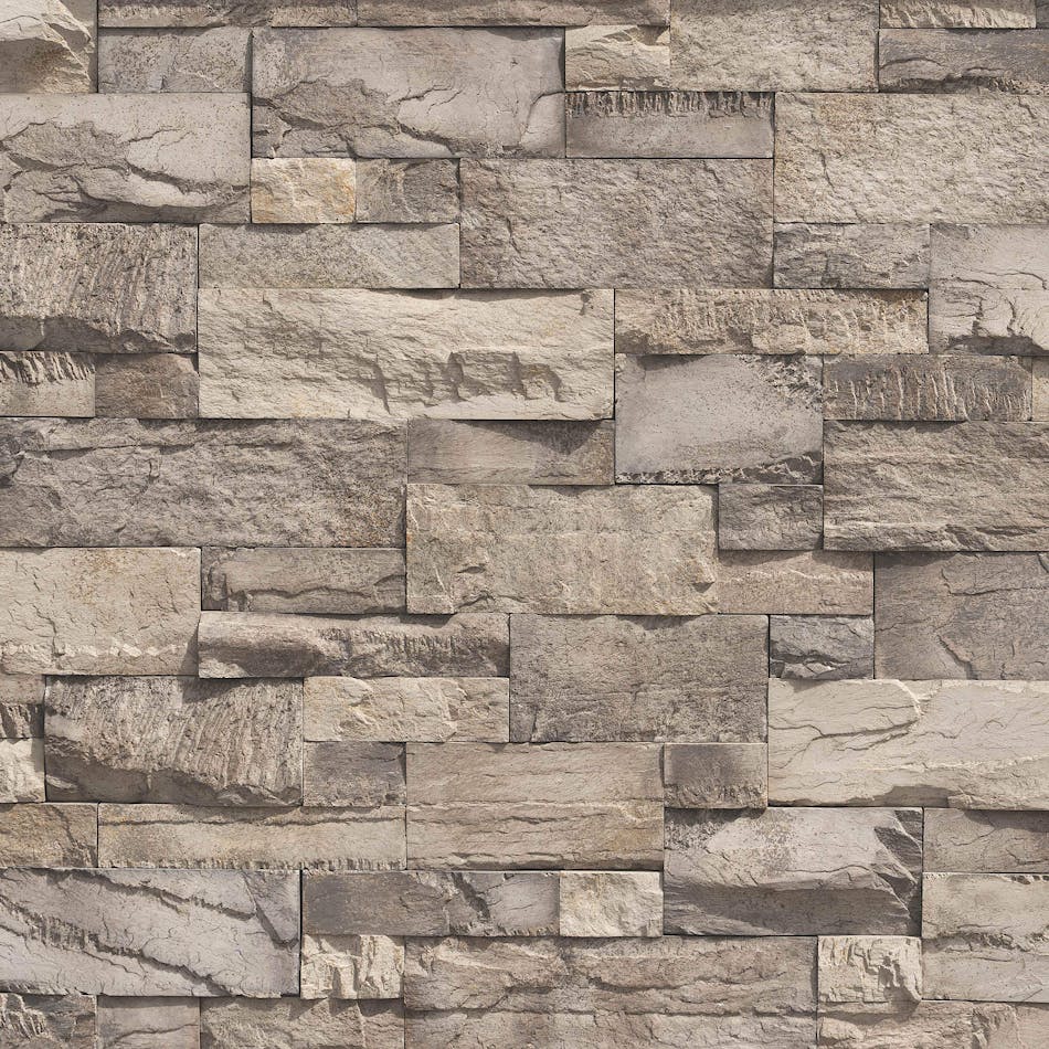 A pre-assembled stone veneer wall in the shade Grey Pearl with pronounced sawtooth texture and stones in varying shapes and sizes.