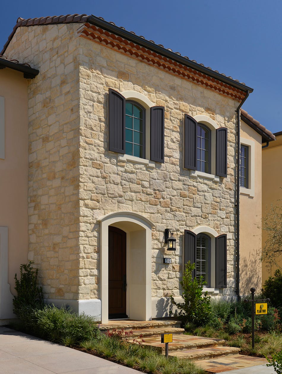 A stunning exterior facade featuring oversized limestone creates a grand entrance to this beautiful home.
